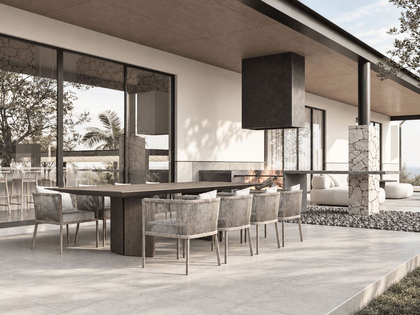 Terraza con chimenea suspendida y mobiliario de exterior por estudio ed